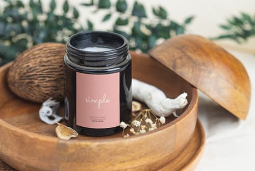 Black candle on wooden tray mockup