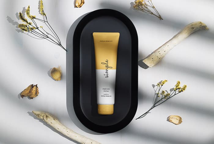 Cosmetic tube on a black tray mockup