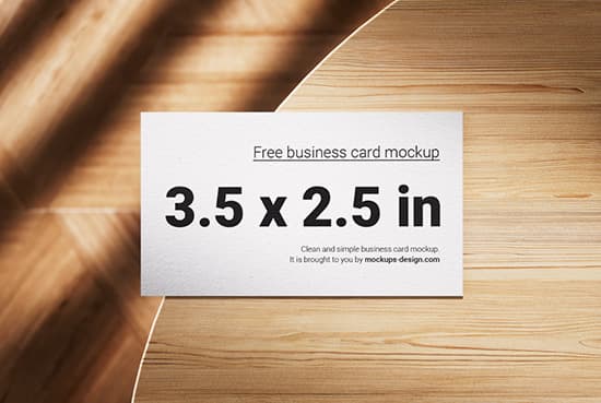 Business cards lying on a wooden table mockup